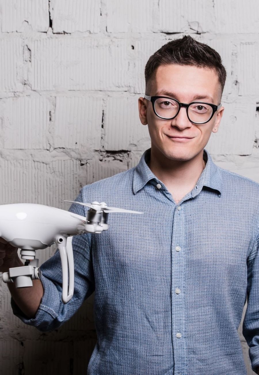 young-stylish-man-in-glasses-with-quadcopter-drone-2023-11-27-05-18-14-utc (1)
